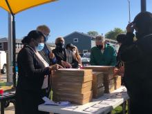From left: HACC Executive Director Rich Monocchio, Robbins Mayor Tyrone Ward and President Preckwinkle distribute laptops to Flowers residents following the announcement on October 7, 2020. From left: HACC Executive Director Rich Monocchio, Robbins Mayor Tyrone Ward and President Preckwinkle distribute laptops to Flowers residents following the announcement on October 7, 2020.